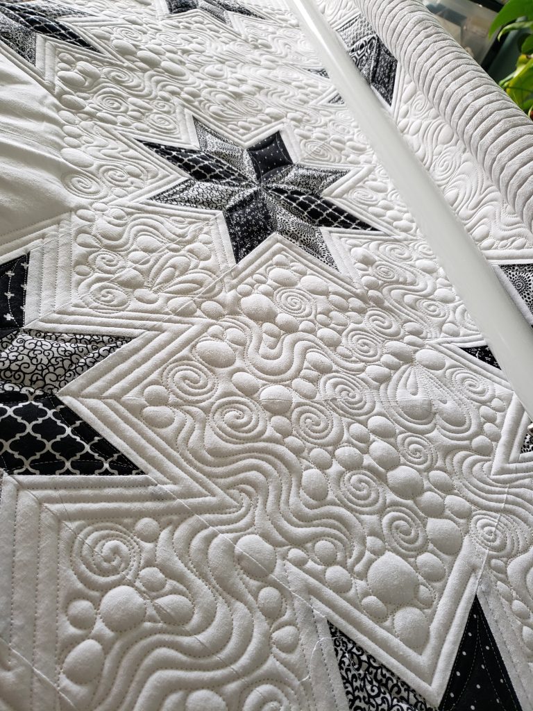 quilts for sale/ Black and White Quilt/handmade Hunter’s Star quilt displayed on a Queen-sized bed