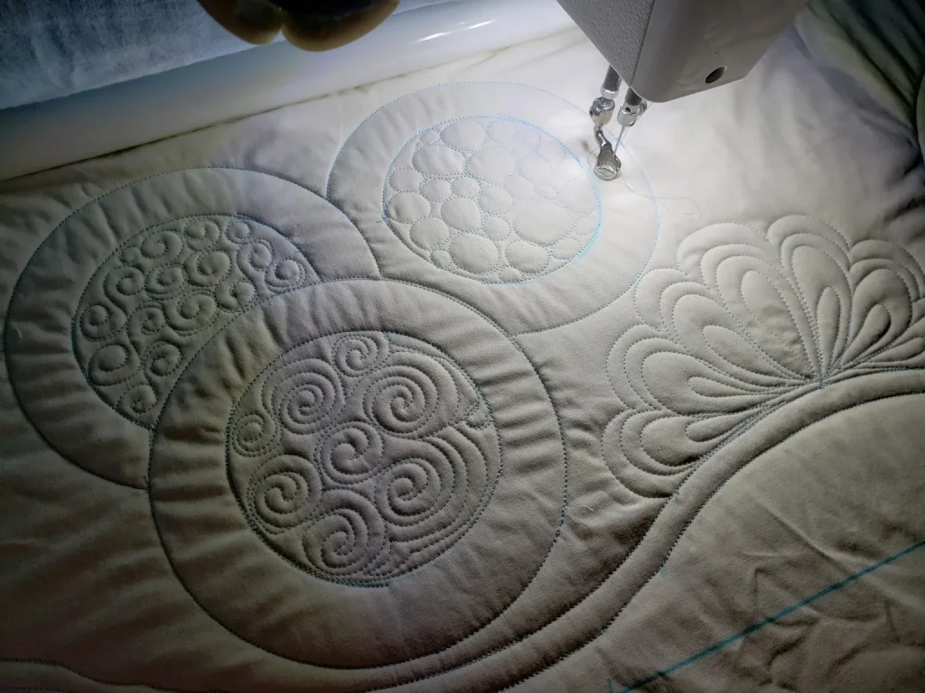 Quilts For Sale/ Quilt for Sale/ Quilt for Sale Handmade Close-up of detailed free-motion stitching in pastel thread on white quilt