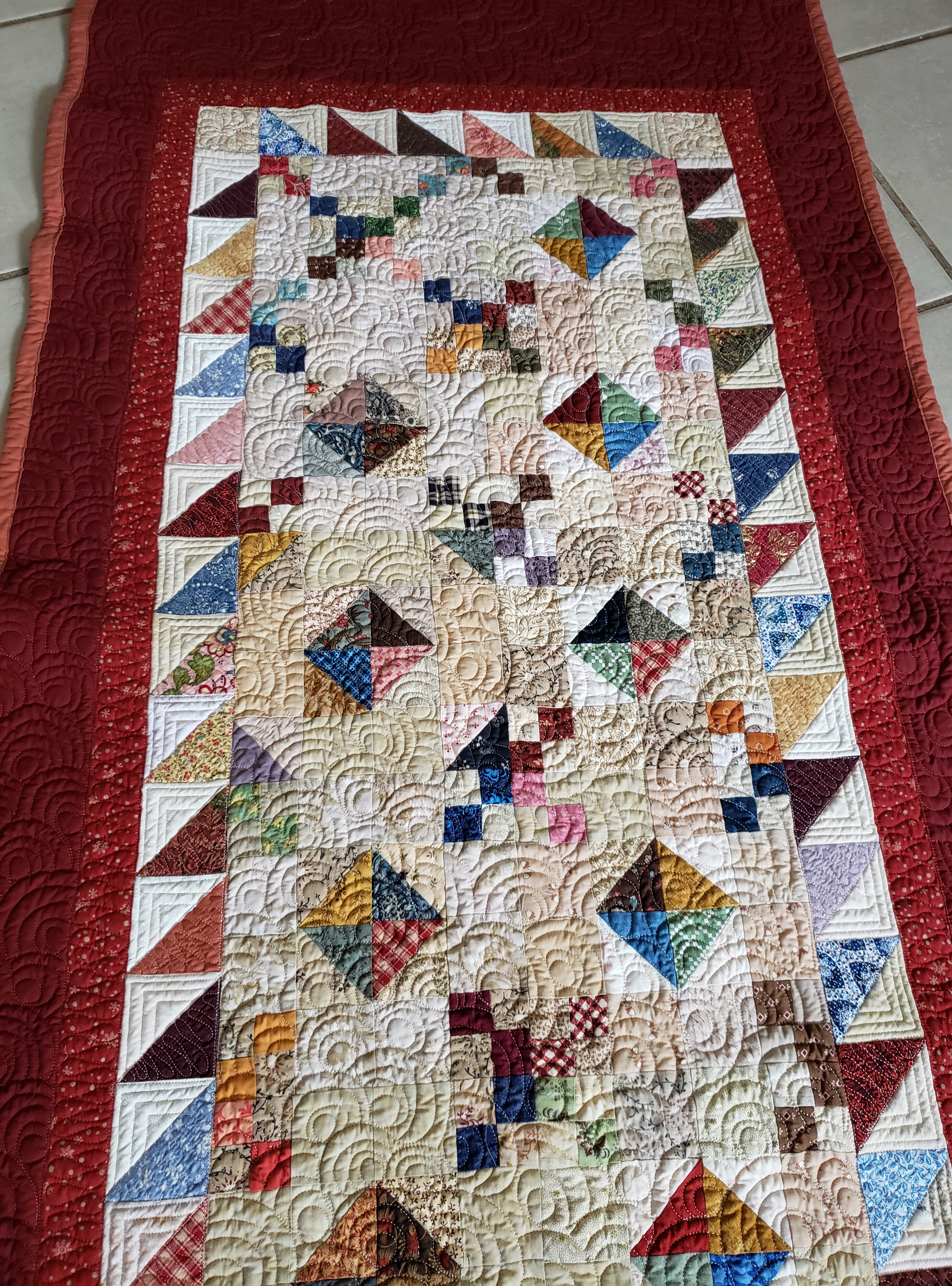 Handmade Quilts/ Handmade quilted rug featuring scrappy patchwork blocks and deep red border, ideal for farmhouse or rustic home décor