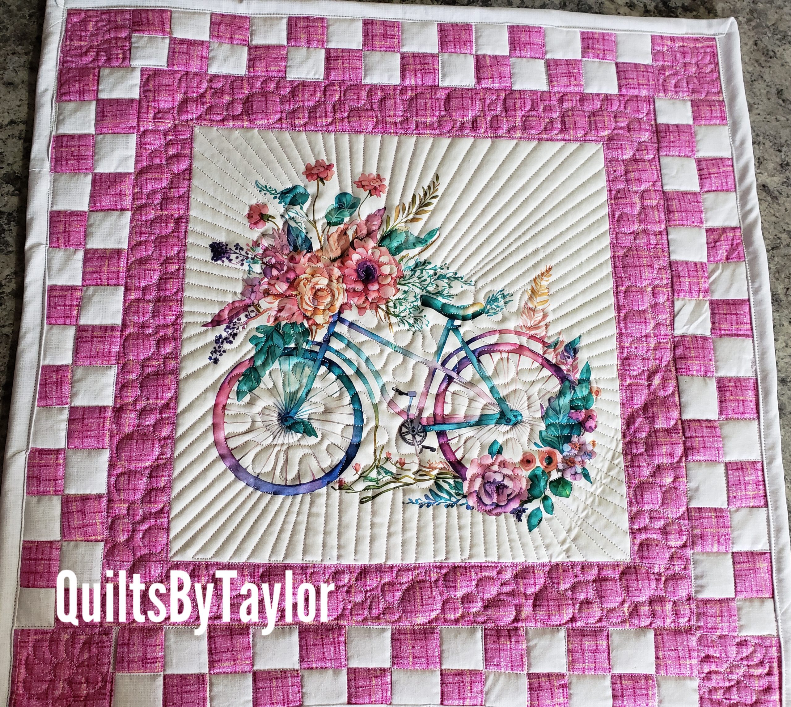 Close-up of the quilting detail on the handmade bicycle quilt, showing radiating stitching lines