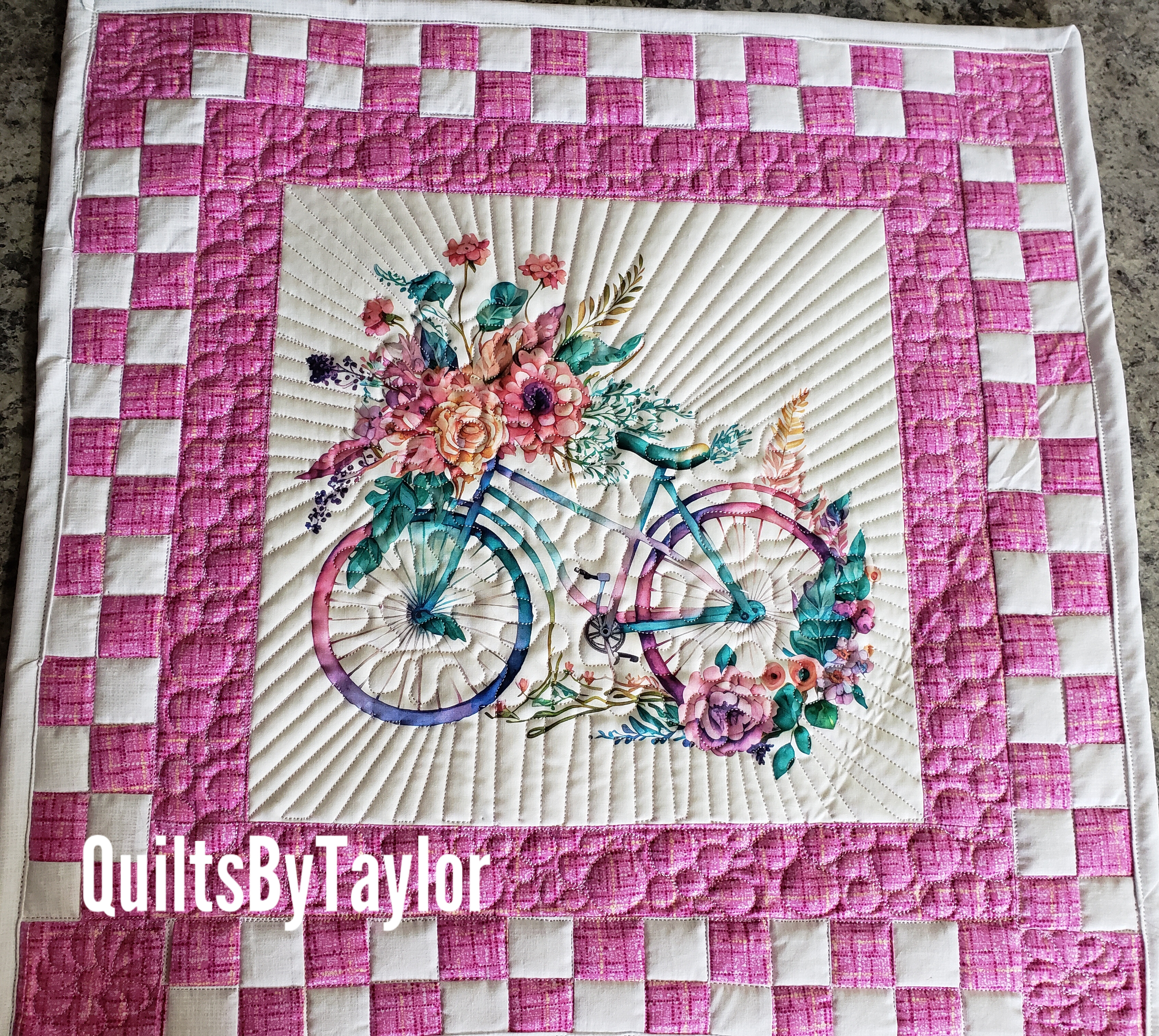 Close-up of the quilting detail on the handmade bicycle quilt, showing radiating stitching lines