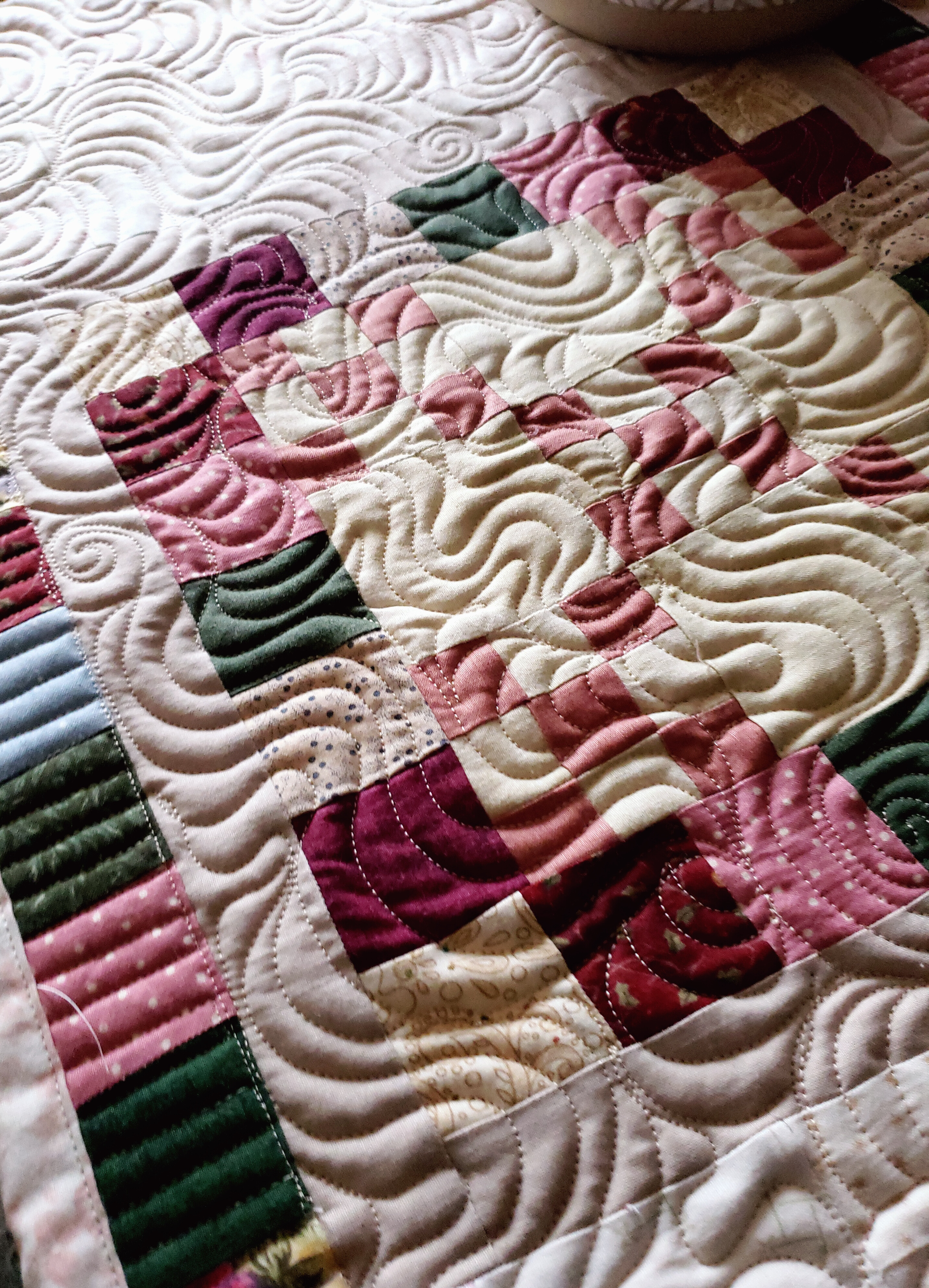 Custom Handmade Quilts/ Patchwork border featuring soft cottage-style colors in a handmade quilted table topper.