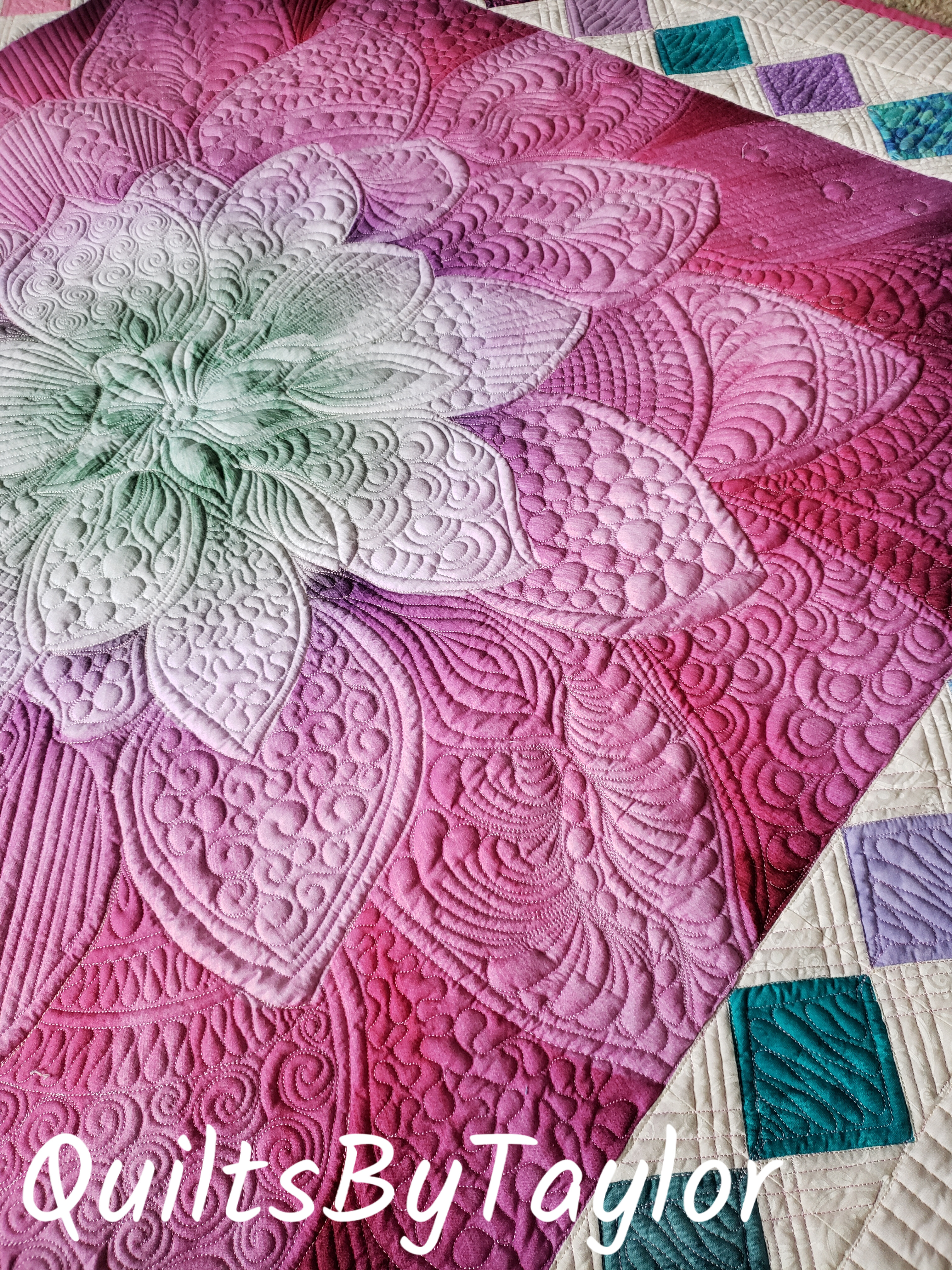 Decorative handmade floral quilt displayed as home decor