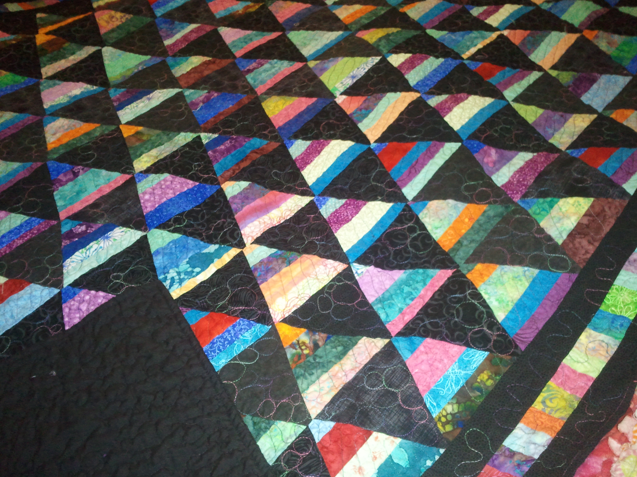 https://quiltsbytaylor.com/crazy-triangles-quilt-in-the-making-multi-colored-with-burgundy/about-me/