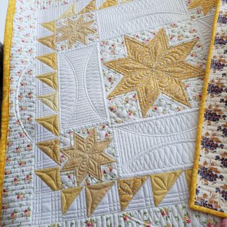 Sunshine Lemoyne Star mini quilt made with 100% cotton and detailed quilting. A one-of-a-kind handmade table topper ready to ship.