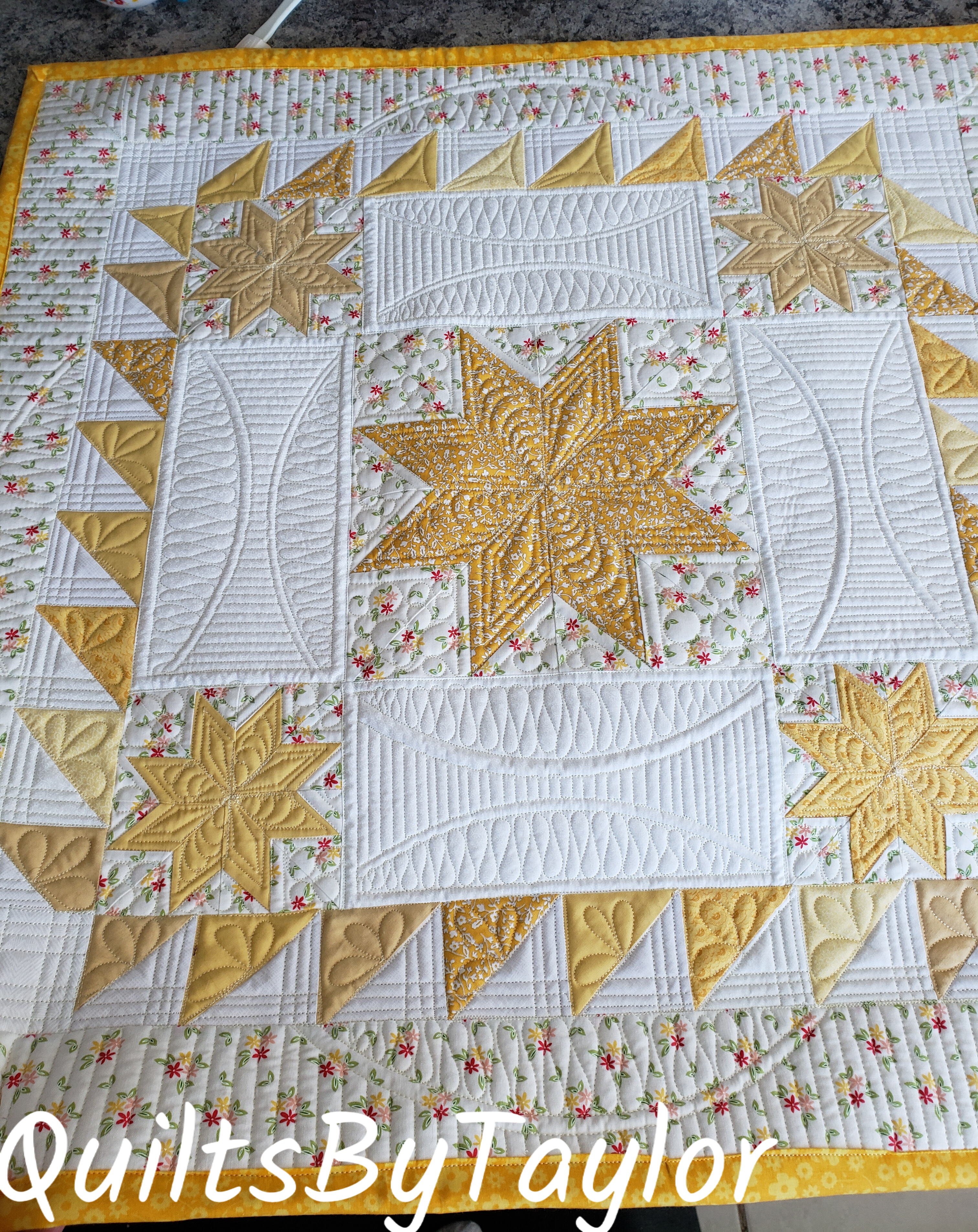 Bright yellow handmade star quilt décor. This Lemoyne Star mini quilt measures 24 x 24 and makes a beautiful table topper or handmade gift.