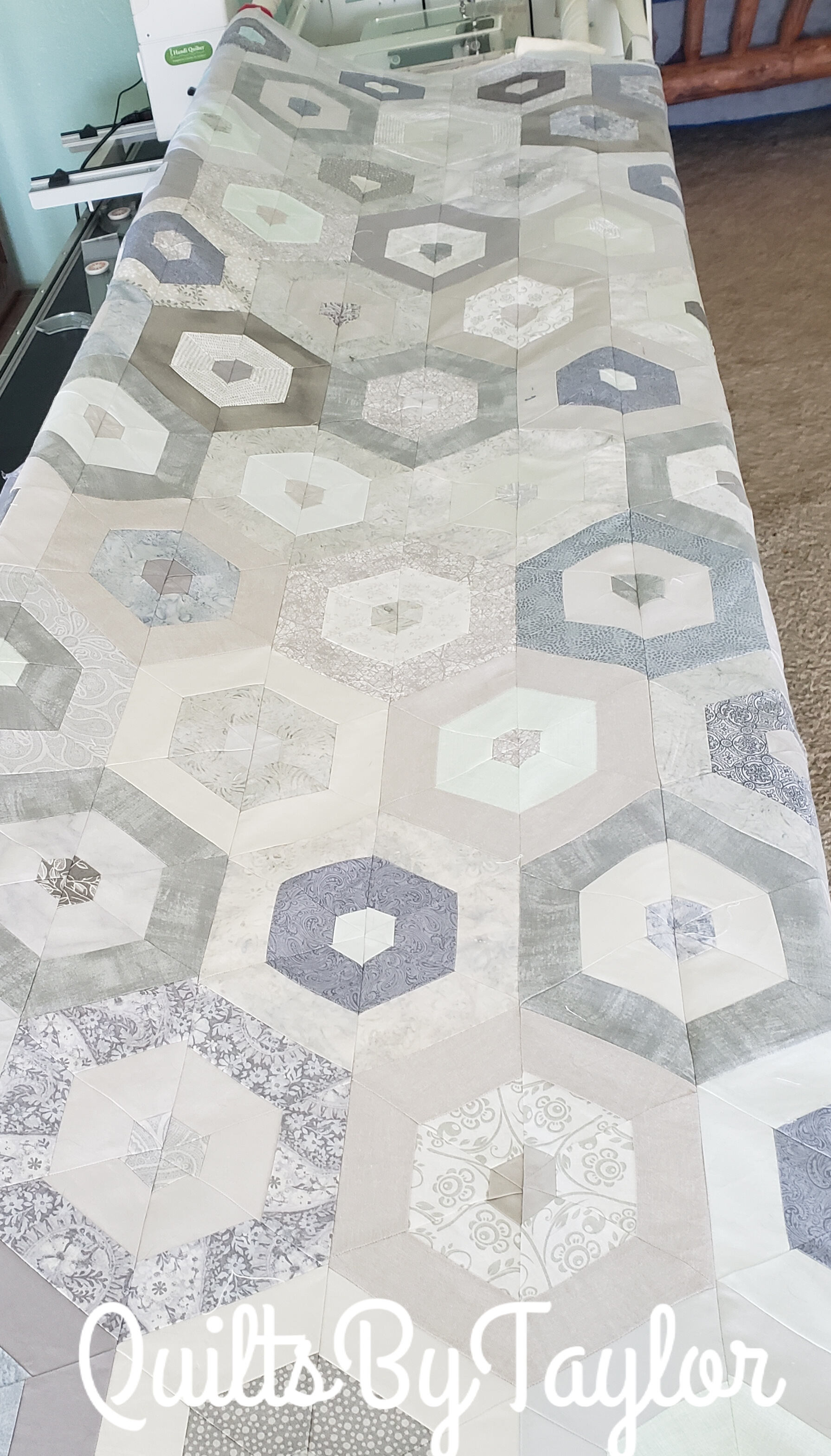 custom handmade quilt top before quilting showing hexagon layout and border design