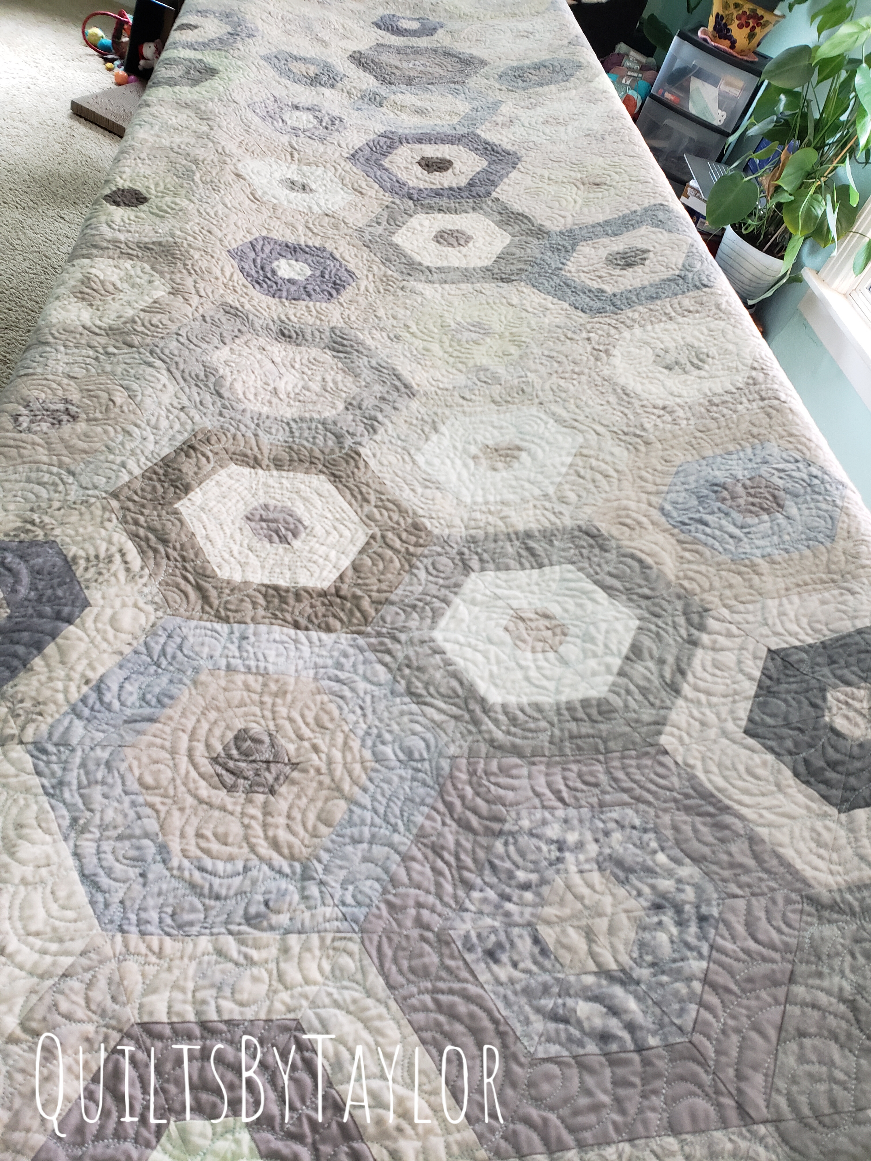 heirloom handmade patchwork quilt with soft flowing quilting design and neutral fabrics