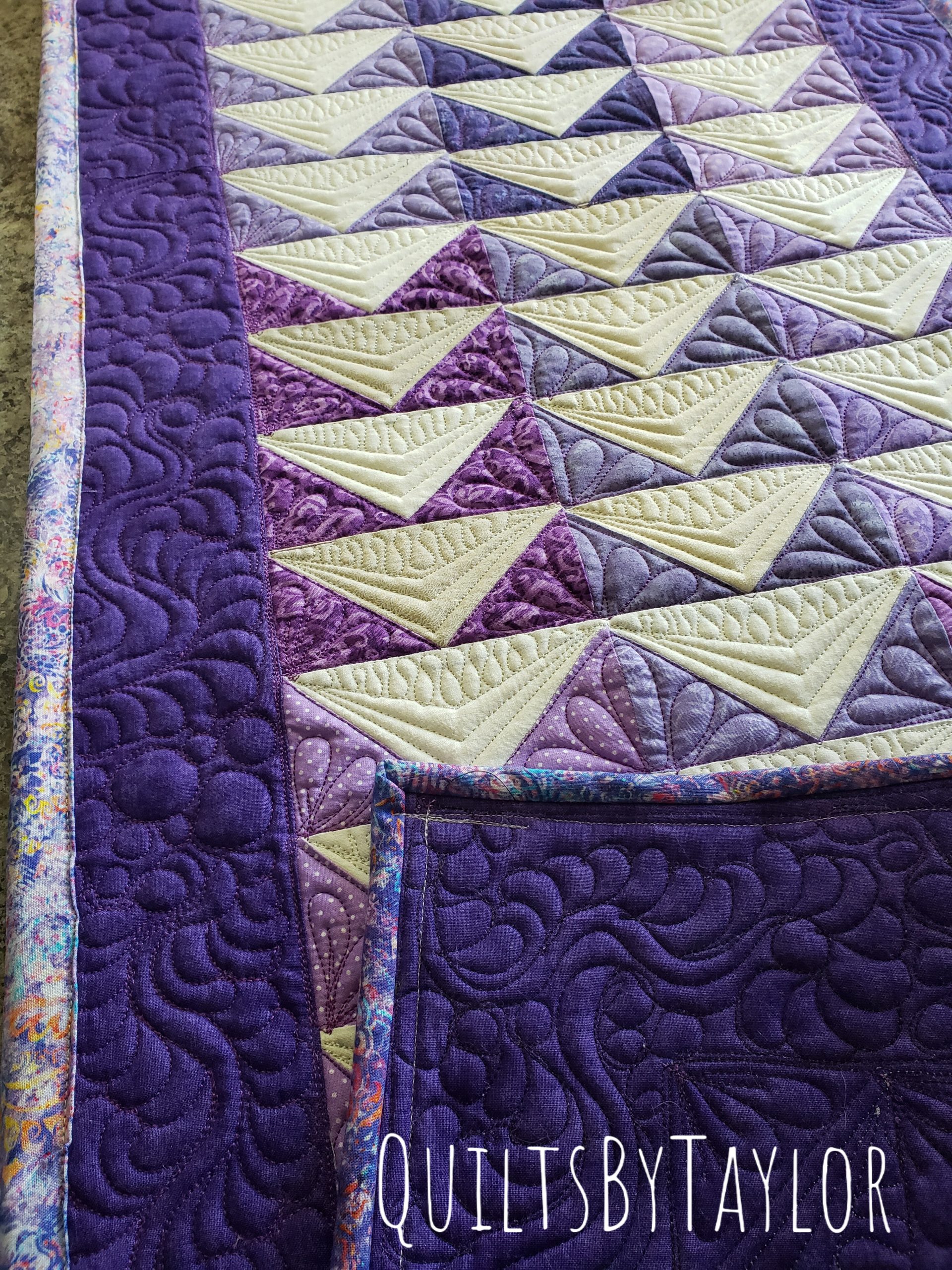 quilts for sale/ Close up of custom free motion quilting on handmade cotton table runner.