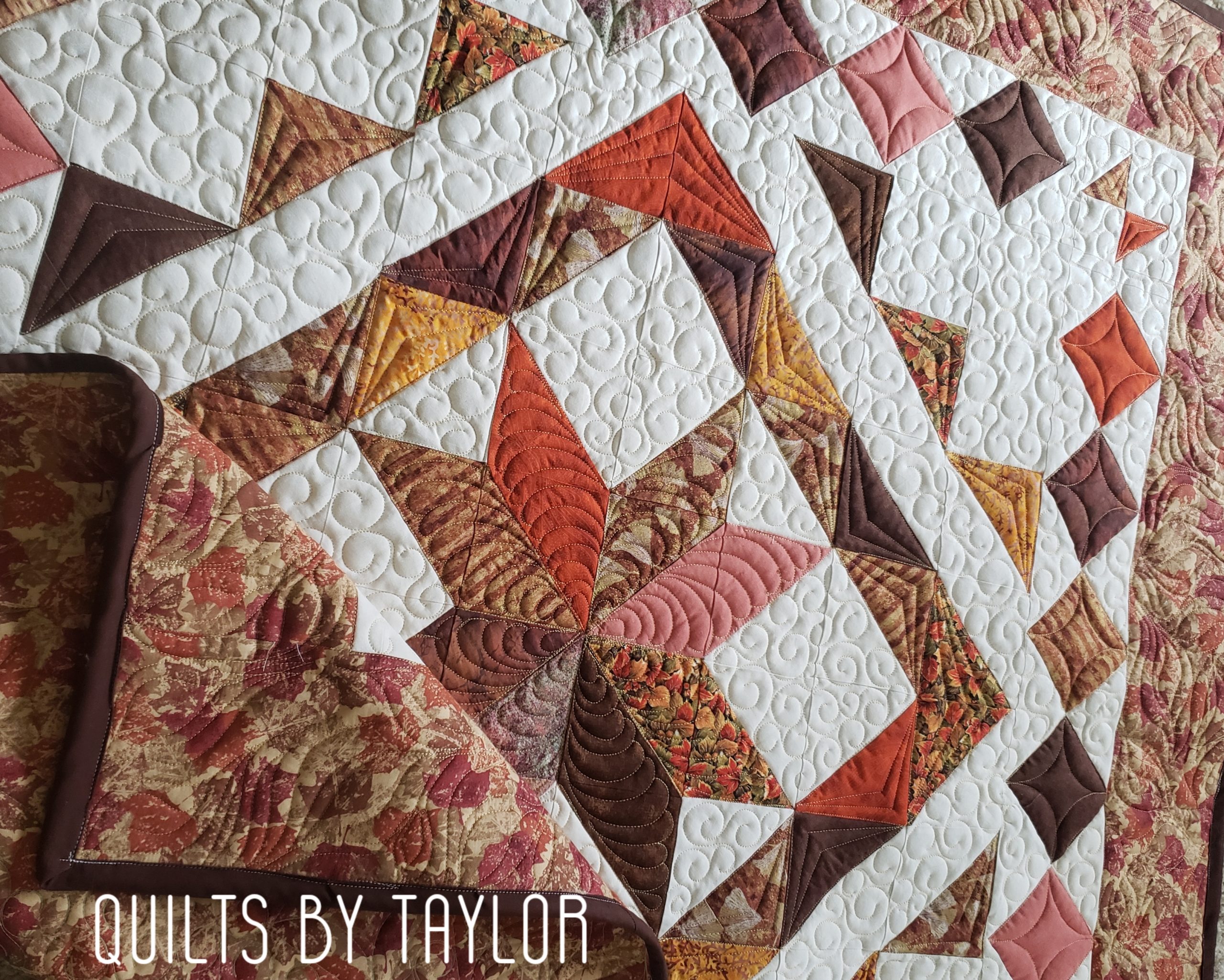 Full view of the 50 by 50 inch Fall Harvest Star decorative quilt in warm autumn colors.